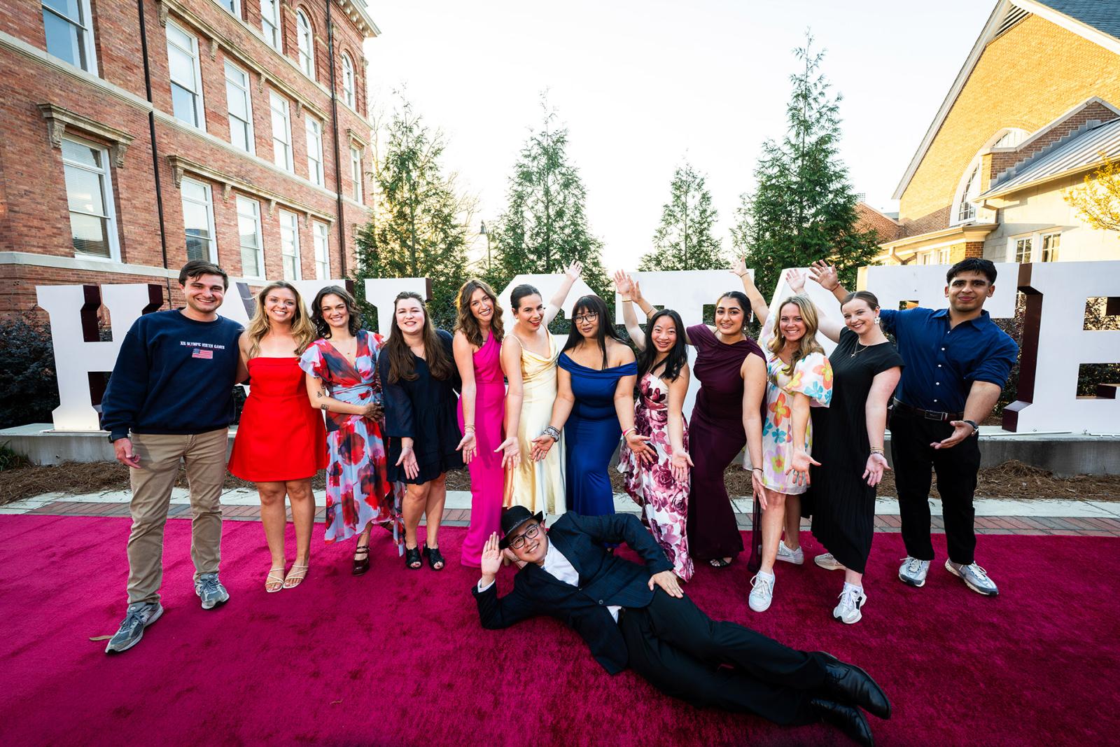 Students pose in front of the Hail State sign on campus